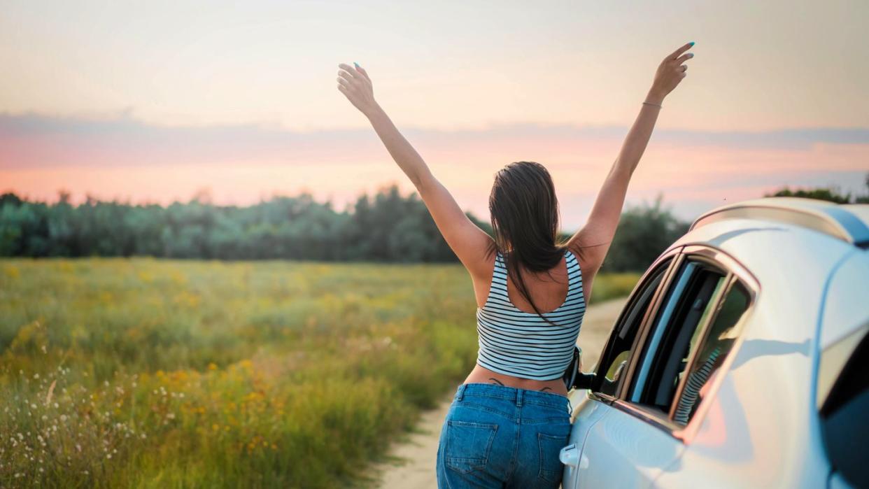 a man standing next to a car