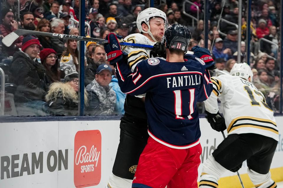 Nov 27, 2023; Columbus, Ohio, USA; Columbus Blue Jackets center Adam Fantilli (11) hits Boston Bruins defenseman Brandon Carlo (25) during the third period of the NHL game at Nationwide Arena. The Blue Jackets won 5-2.
