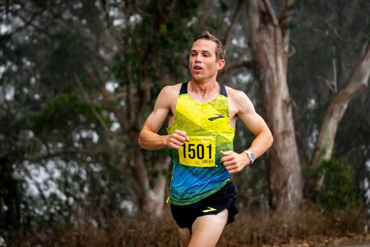 CJ Albertson running with a yellow singlet