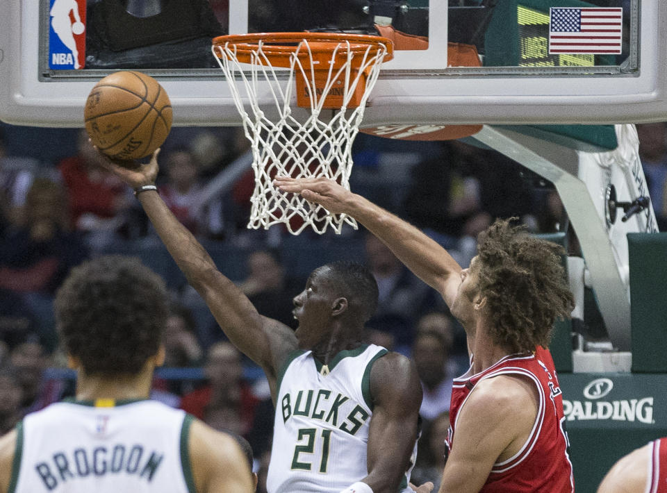 Chicago Bulls' Robin Lopez cannot stop Milwaukee Bucks' Tony Snell as Snell puts up a reverse layup during the second half of an NBA basketball game Sunday, March 26, 2017, in Milwaukee. (AP Photo/Tom Lynn)