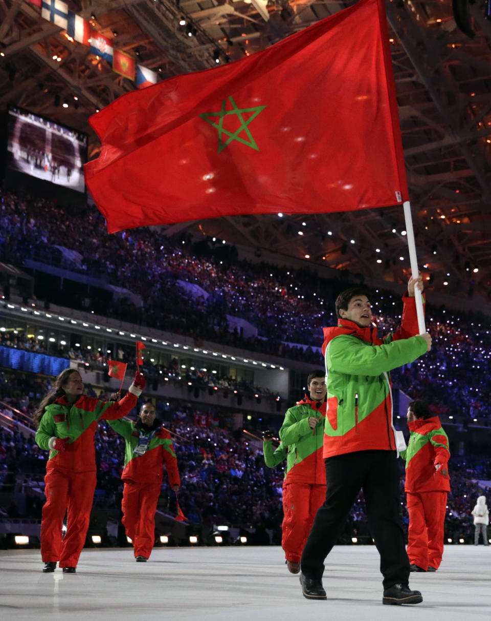 Adam Lamhamedi of Morocco carries the national flag during the opening ceremony of the 2014 Winter Olympics in Sochi, Russia, Friday, Feb. 7, 2014. (AP Photo/Matt Dunham)