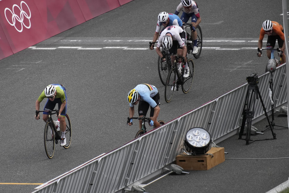 Tadej Pogacar of Slovenia, left, and Wout van Aert of Belgium, battle for a photo finish for silver and bronze medals during the men's cycling road race at the 2020 Summer Olympics, Saturday, July 24, 2021, in Oyama, Japan. (AP Photo/Christophe Ena)