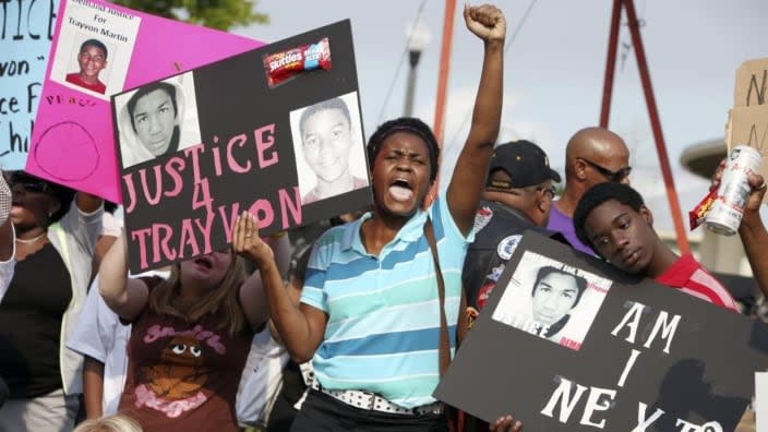 In this March 2012 file photo, protestors Lakesha Hall (center) and her son, Calvin Simms (right), participate in a rally for Trayvon Martin, the black teenager who was fatally shot by George Zimmerman, a neighborhood watch captain in Sanford, Fla. (Photo: Julie Fletcher/AP, File)