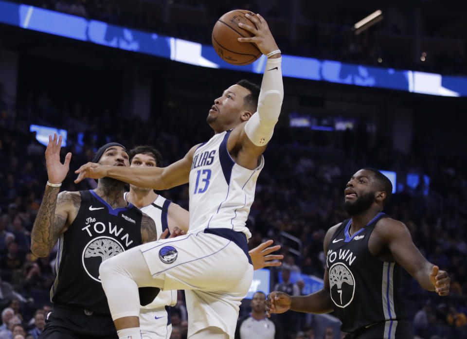 Dallas Mavericks' Jalen Brunson, right, shoots between Golden State Warriors' Willie Cauley-Stein, left, and Eric Paschall (7) during the first half of an NBA basketball game Tuesday, Jan. 14, 2020, in San Francisco. (AP Photo/Ben Margot)