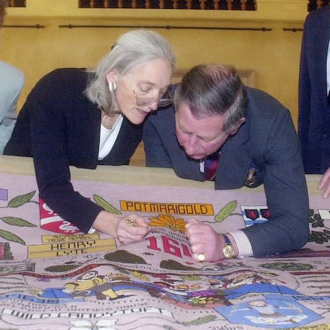 The Prince of Wales puts the last stitch in the tapestry in 2000 - Credit: PA