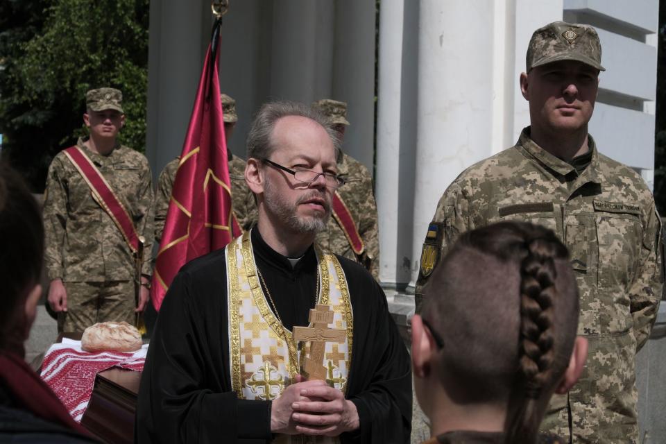 An Orthodox priest delivers a eulogy at the farewell ceremony of U.S. volunteer Christopher Campbell in Kyiv on May 5, 2023. (Francis Farrell/The Kyiv Independent)
