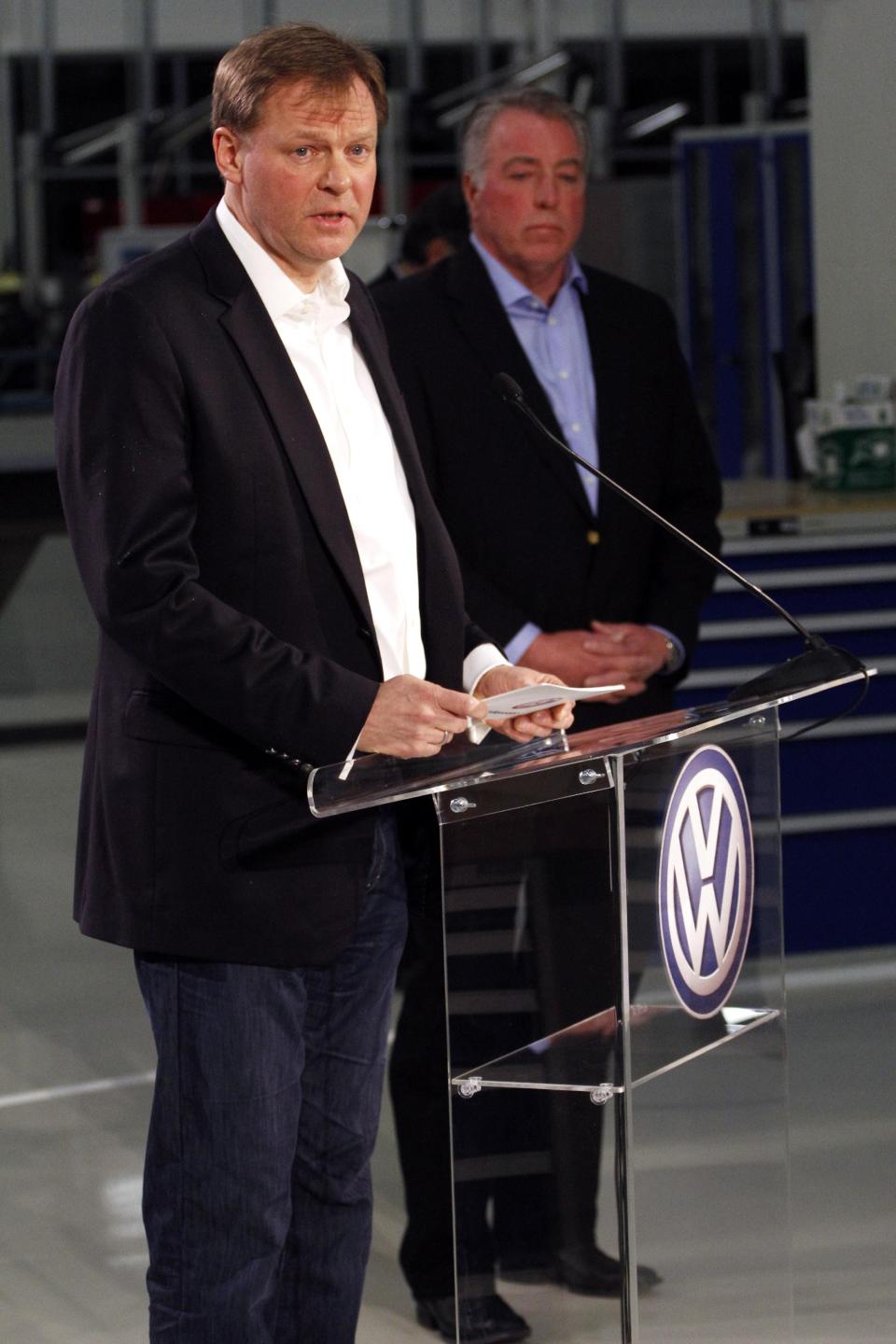 Frank Fischer, Chairman and CEO of the Volkswagen Group of America, left, speaks on behalf of the company after it was announced that Volkswagen employees voted to deny representation by the United Auto Workers union, as Gary Casteel, UAW Region 8 Director, looks on from behind, concluding a three day election which ended this evening Friday, Feb. 14, 2014, in Chattanooga, Tenn. (AP Photo/Chattanooga Times Free Press, Dan Henry) THE DAILY CITIZEN OUT; NOOGA.COM OUT; CLEVELAND DAILY BANNER OUT; LOCAL INTERNET OUT