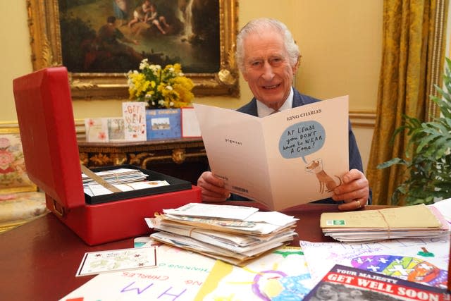 The King reads cards and messages, sent by well-wishers