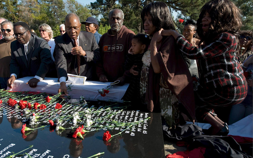 Relatives at a memorial to Jonestown in the US. Source: AP