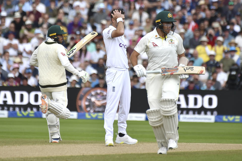 England's James Anderson, centre, reacts while Australia's Scott Boland, right, and Australia's Usman Khawaja add runs during day five of the first Ashes Test cricket match, at Edgbaston, Birmingham, England, Tuesday, June 20 2023. (AP Photo/Rui Vieira)