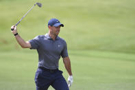 Rory McIlroy swings his club as he walks onto the 18th green during the second round of the Wells Fargo Championship golf tournament at Quail Hollow Club in Charlotte, N.C., Friday, May 7, 2021. (Jeff Siner/The Charlotte Observer via AP)