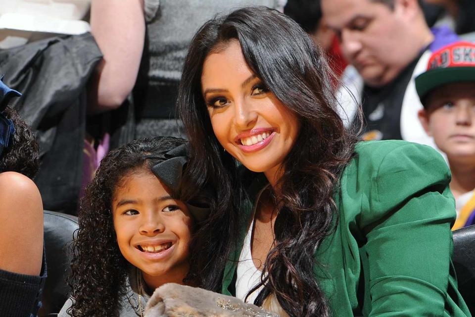 <p>Andrew D. Bernstein/NBAE via Getty</p> Vanessa Bryant (R) and Gianna (C) pose for a photograph during a Los Angeles Lakers game at Staples Center on December 25, 2012 in Los Angeles, California.