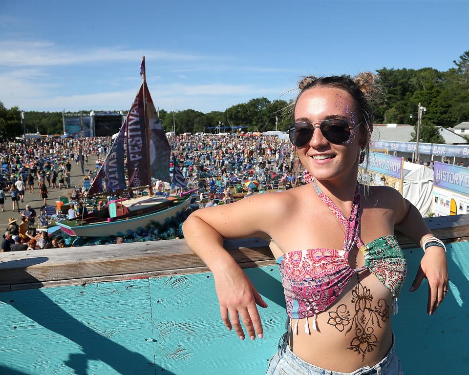 Grace Godfrey, of Lebanon, New Hampshire, gets her photo taken from the viewing tower at the 2022 Levitate Music Festival at the Marshfield Fairgrounds.