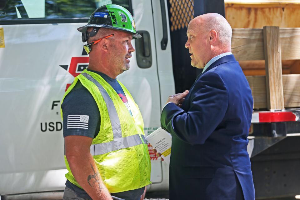 Lonny Mitchell, left, talks with White House Infrastructure Coordinator Mitch Landrieu, left, prior to  a news conference on Wednesday, July 13, 2022, on South 12th Wtreet where lead pipe replacement is underway. Mitchell is part of the work crew working at the site.