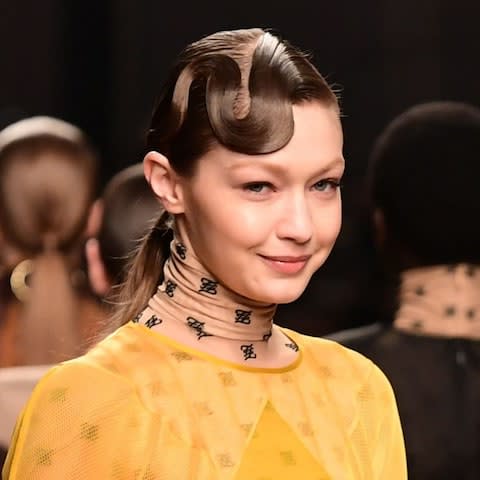 Ponytails were tied at the nape of the neck in tribute to Karl Lagerfeld - Credit: &nbsp;MIGUEL MEDINA/AFP