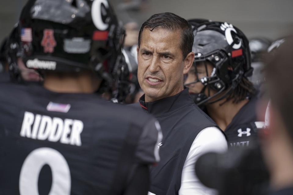 Cincinnati coach Luke Fickell speaks with quarterback Desmond Ridder before a game against Miami of Ohio on Sept. 4.