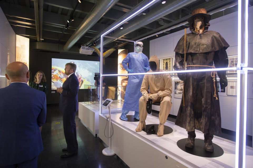 Dutch King Willem-Alexander, center, curator Mieneke te Hennepe, second left, and director Amito Haarhuis, left, tour the "Contagious!" exhibit at Rijksmuseum Boerhave in Leiden, Netherlands, Thursday, July 16, 2020. The museum finally opened an exhibition Thursday on contagious diseases through the ages after a long delay caused by the disease currently sweeping the world, COVID-19. (AP Photo/Peter Dejong, Pool)