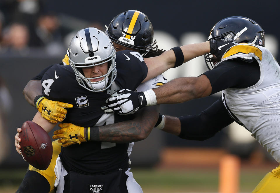 <p>Oakland Raiders quarterback Derek Carr (4) is sacked by Pittsburgh Steelers outside linebacker Bud Dupree, rear, as defensive end Cameron Heyward, right, approaches during the second half of an NFL football game in Oakland, Calif., Sunday, Dec. 9, 2018. (AP Photo/D. Ross Cameron) </p>