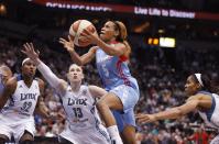 Atlanta Dream guard Jasmine Thomas (5) pushes up to the basket against Minnesota Lynx guard Lindsay Whalen (13) during Game 1 of the WNBA basketball Finals, Sunday, Oct. 6, 2013, in Minneapolis. (AP Photo/Stacy Bengs)