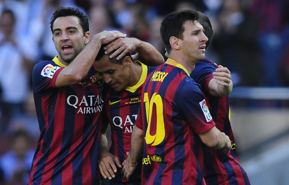 FC Barcelona's Alexis Sanchez, second left, celebrates scoring against Getafe with his teammates Xavi Hernandez, left, and Lionel Messi, from Argentina during a Spanish La Liga soccer match at the Camp Nou stadium in Barcelona, Spain, Saturday May 3, 2014. (AP Photo/Manu Fernandez)