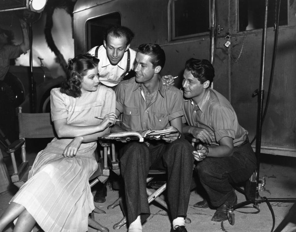 <p>The actress discusses a scene on the set of <em>Next Time I Marry</em> with the film's director, Garson Kanin, her costar James Ellison and Ellison's stand-in, Allan Kneip. </p>