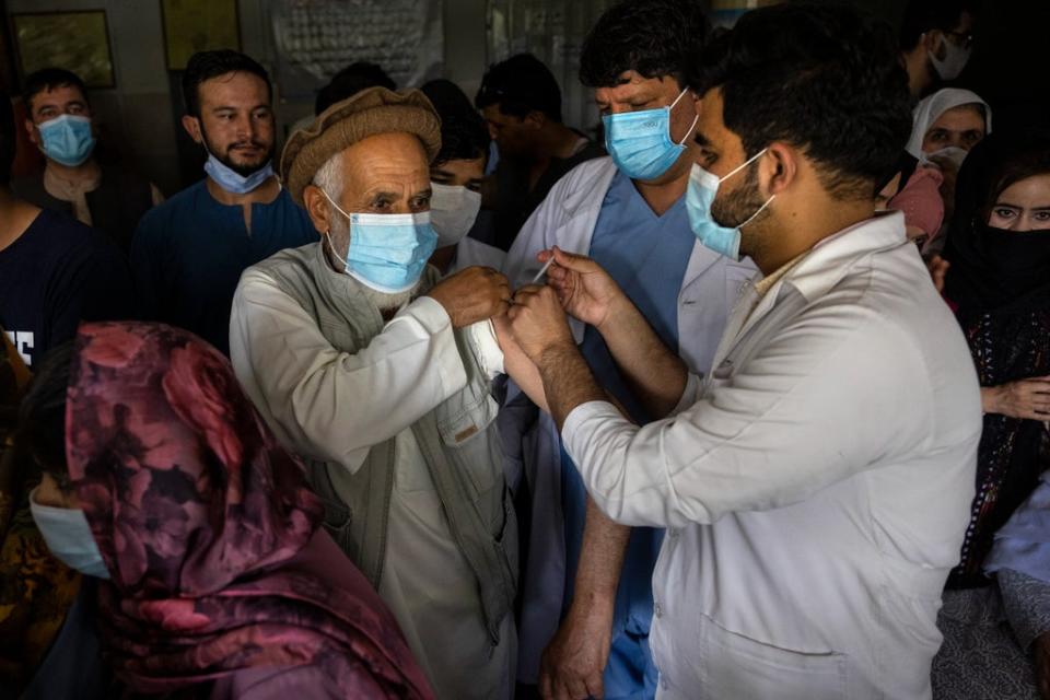 Doctor Roheed Mureed (right) vaccinates Afghans with the J&J vaccine at the Wazir Akbar Khan hospital on July 14, 2021 in Kabul, Afghanistan, July 14, 2021. (Getty Images)