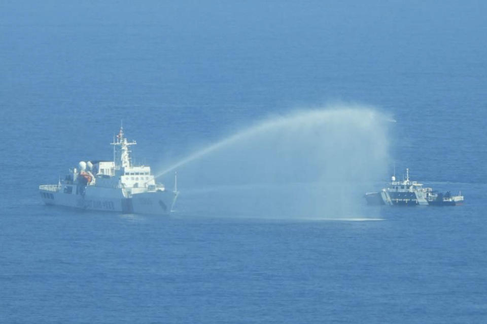 In this photo provided by the Philippine Coast Guard, a Chinese Coast Guard ship, left, uses its water cannons on a Philippine Bureau of Fisheries and Aquatic Resources (BFAR) vessel as it approaches Scarborough Shoal in the disputed South China Sea on Saturday Dec. 9, 2023. The Philippines and its treaty ally, the United States, separately condemned a high-seas assault Saturday by the Chinese coast guard and suspected militia ships that repeatedly blasted water cannons to block three Philippine fisheries vessels from a disputed shoal in the South China Sea. (Philippine Coast Guard via AP)