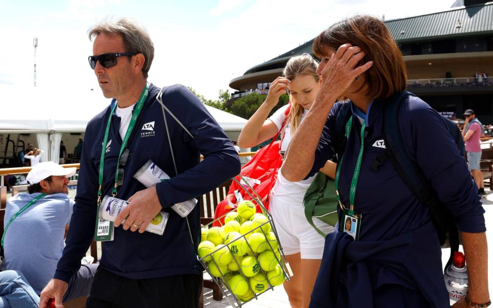 Great Britain's Katie Boulter (centre) with coaches Jeremy Bates (left) and Biljana Veselinovic makes her way to the practice courts during day five of the 2022 Wimbledon Championships at the All England Lawn Tennis and Croquet Club, Wimbledon - PA