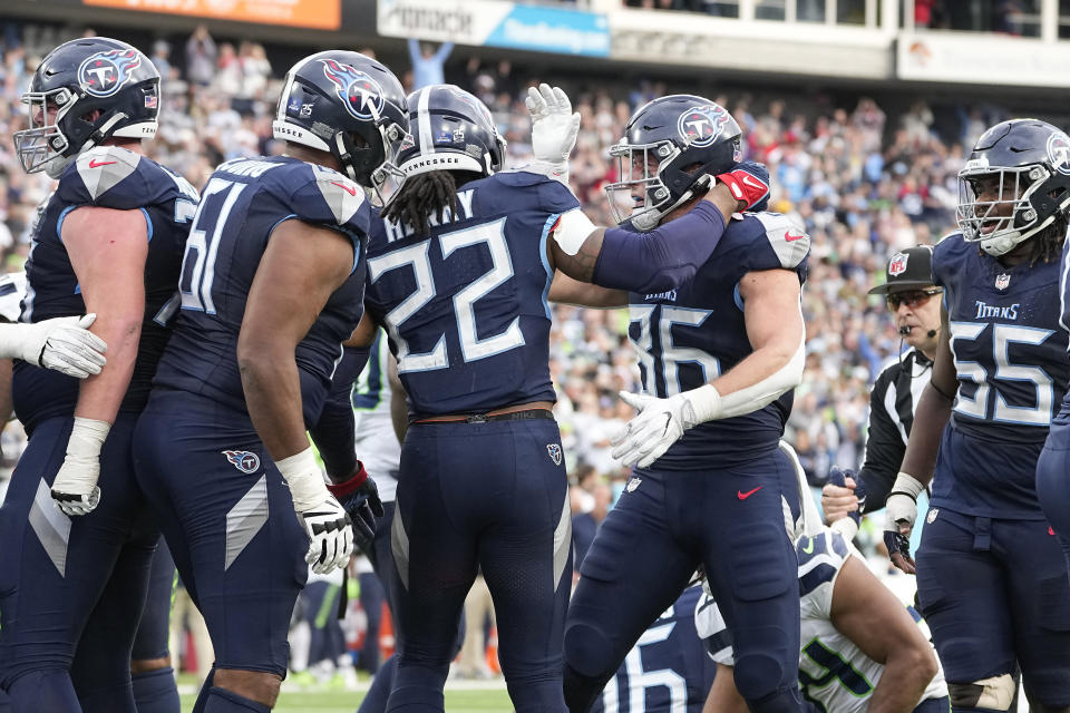 Tennessee Titans running back Derrick Henry (22) is congratulated by tight end Kevin Rader (86) after scoring against the Seattle Seahawks during the second half of an NFL football game on Sunday, Dec. 24, 2023, in Nashville, Tenn. (AP Photo/George Walker IV)