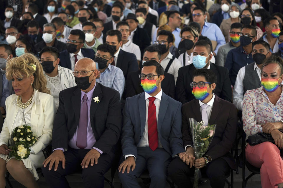 Couples of the same sex attend a mass wedding ceremony organized by city authorities as part of the LGBTQ pride month celebrations, in Mexico City, Friday, June 24, 2022. (AP Photo/Fernando Llano)