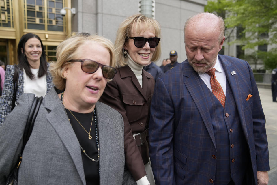 E. Jean Carroll, center, walks out of Manhattan federal court, Tuesday, May 9, 2023, in New York. A jury has found Donald Trump liable for sexually abusing the advice columnist in 1996, awarding her $5 million in a judgment that could haunt the former president as he campaigns to regain the White House. (AP Photo/John Minchillo)