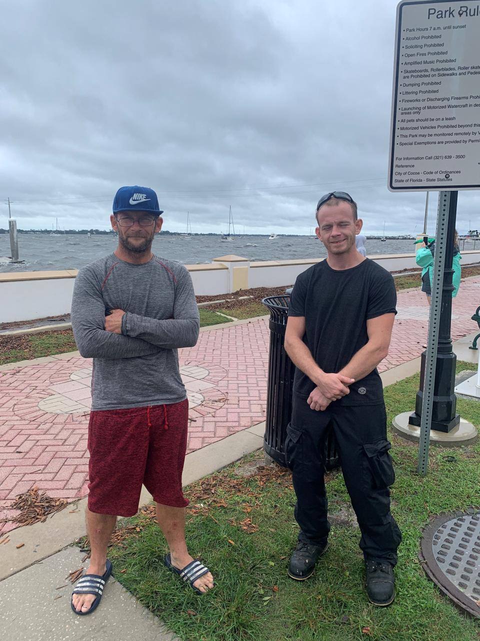 Dustin Andric, left, and Nate Mango, of Ohio, stopped in Cocoa Village on Thursday morning to check out the rough water in the Indian River.