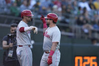 Philadelphia Phillies' Kyle Schwarber, right, celebrates with Trea Turner, left, after hitting a solo home run during the first inning of a baseball game against the Oakland Athletics in Oakland, Calif., Friday, June 16, 2023. (AP Photo/Godofredo A. Vásquez)