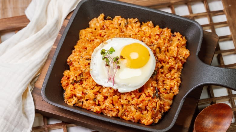 Fried rice with egg in black pan 