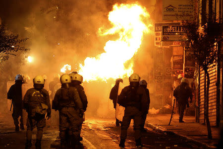 A petrol bomb explodes next to riot police during clashes following an anniversary rally marking the 2008 police shooting of 15-year-old student, Alexandros Grigoropoulos, in Athens, Greece, December 6, 2016. REUTERS/Alkis Konstantinidis