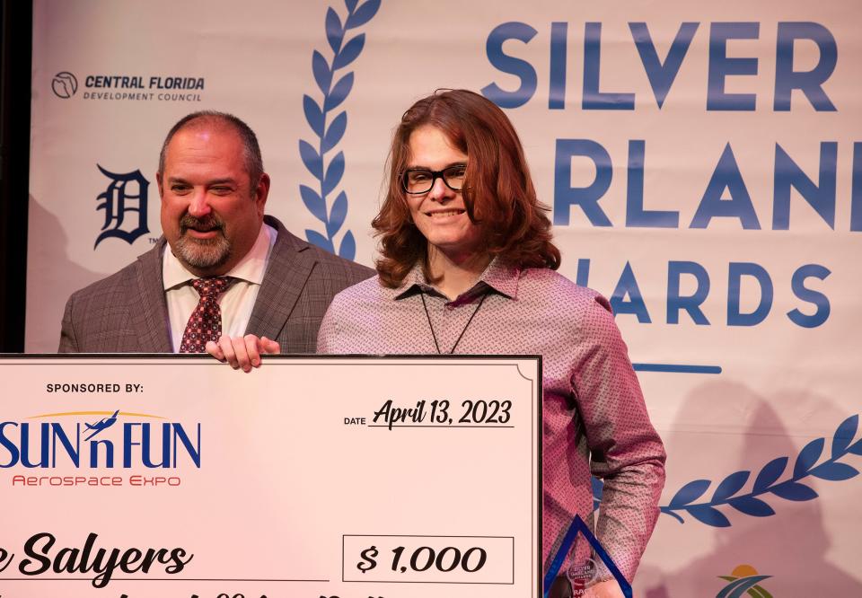 Superintendent of Schools Frederick Heid presents Race Salyers of Winter Haven High School with the Silver Garland Award for Aerospace during the 2023 Silver Garland Awards at the AdventHealth Fieldhouse and Conference Center in Winter Haven. The Aerospace category was one of two new categories added to the awards this year.