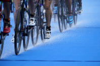 Water trails off the bikes as Valerie Barthelemy of Belgium competes during the women's individual triathlon competition at the 2020 Summer Olympics, Tuesday, July 27, 2021, in Tokyo, Japan. (AP Photo/David Goldman)