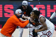 Illinois head coach Brad Underwood celebrates with players Ayo Dosunmu, right, Trent Frazier, center, and Giorgi Bezhanishvili, top, after defeating Ohio State in overtime in a NCAA college basketball championship game at the Big Ten Conference tournament, Sunday, March 14, 2021, in Indianapolis. (AP Photo/Michael Conroy)
