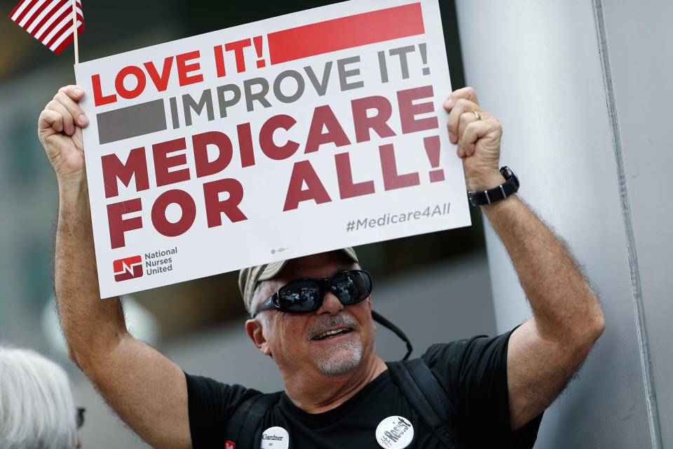 <p>Retired emergency Dr. James Winkler, of Denver, waves a placard during a protest, Friday, June 23, 2017, in downtown Denver, against the Republican health bill that was recently unveiled in the U.S. Senate. (Photo: David Zalubowski/AP) </p>