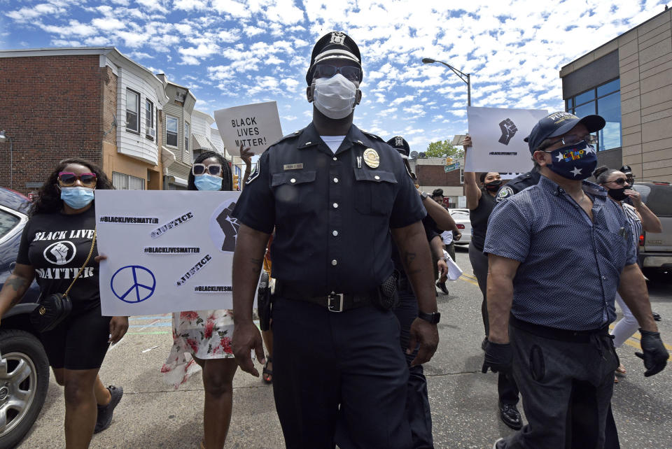 Lt. Zack James of the Camden County Metro Police Department marches along with demonstrators in Camden, N.J., on May 30.