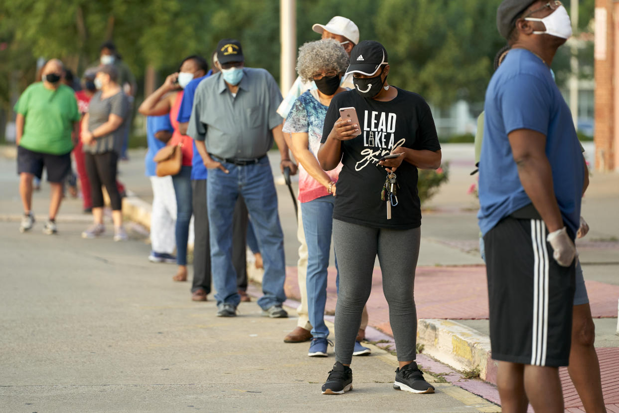 Voters stand in line 