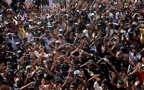 Hundreds of Rohingya refugees shout slogans as they protest against their repatriation at the Unchiprang camp - Credit:  MOHAMMAD PONIR HOSSAIN/ REUTERS 