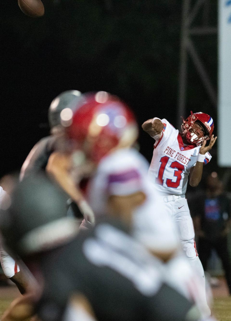 Quarterback James Clark (13) launches a pass during the Pine Forest vs Tate football game at Tate High School in Cantonment on Friday, Aug. 25, 2023.