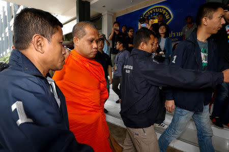 An unidentified assistant abbot of Golden Mount Temple is escorted by police officers at the Thai Police Crime Suppression Division headquarters in Bangkok, Thailand, May 24, 2018. REUTERS/Stringer