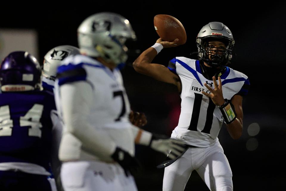 First Coast quarterback Rodney Tisdale Jr. (11) looks to pass an October 2022 game against Fletcher.