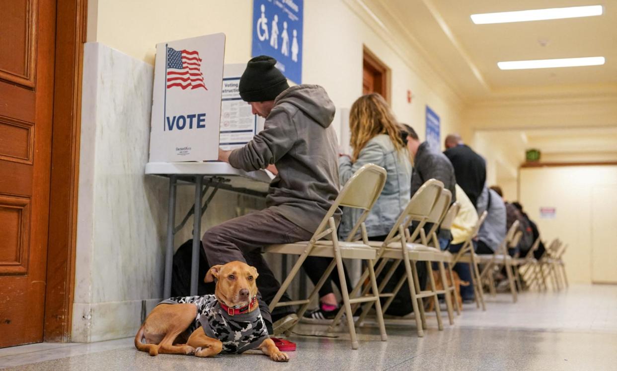 <span>People vote at San Francisco city hall in California on 5 March 2024. </span><span>Photograph: Loren Elliott/Reuters</span>
