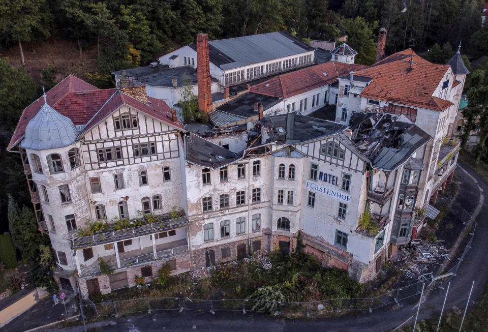 The abandoned and wrecked "Fuerstenhof" hotel is seen in Eisenach, eastern Germany, Monday, Sept. 21, 2020. The once famous hotel where Adolf Hitler delivered a speech in 1932 was closed in 1996. Thirty years after Germany was reunited on Oct. 3, 1990, many once-decrepit city centers in the formerly communist east have been painstakingly restored and new factories have sprung up. But many companies and facilities didn't survive the abrupt transition to capitalism inefficient companies found themselves struggling to compete in a market economy, while demand for eastern products slumped and outdated facilities were shut down. (AP Photo/Michael Probst)