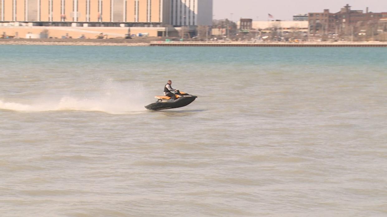 It was a day for record-breaking heat in Windsor, and one resident made use of the warm weather by hitting the Detroit River on a jet ski.  (Michael Evans/CBC - image credit)