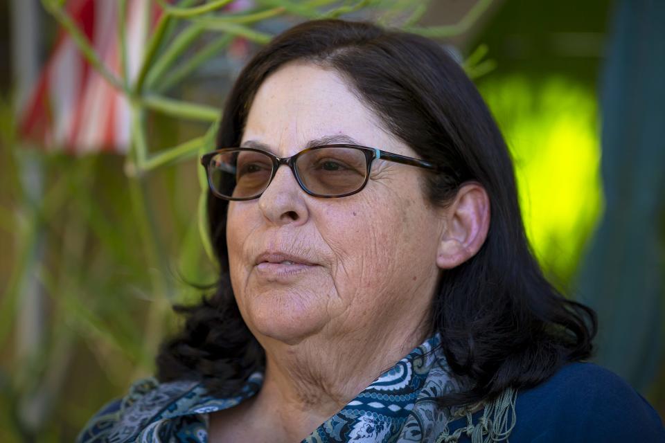 Deborah Torzone sits in the front yard of her Tempe home on April 8, 2022.