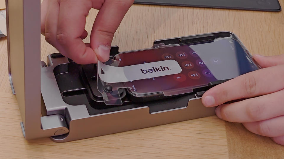 The Belkin UltraGlass screen protector being applied to the iPhone 15 Pro Max